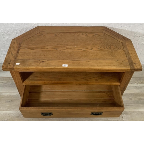 204 - A modern oak TV stand - approx. 56cm high x 102cm wide x 51cm deep