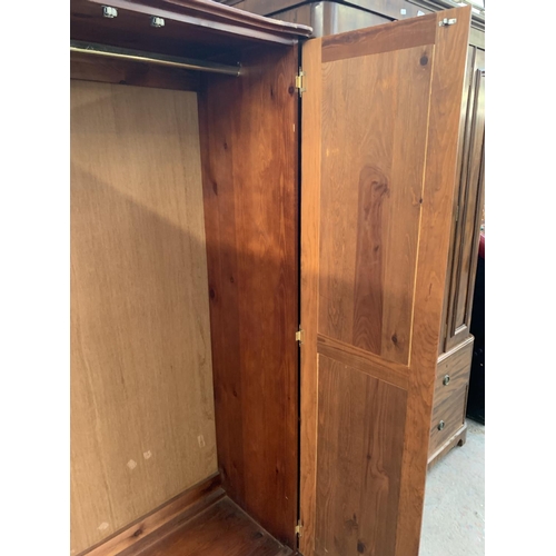 205 - A modern stained pine double wardrobe - approx. 180cm high x 95cm wide x 50cm deep