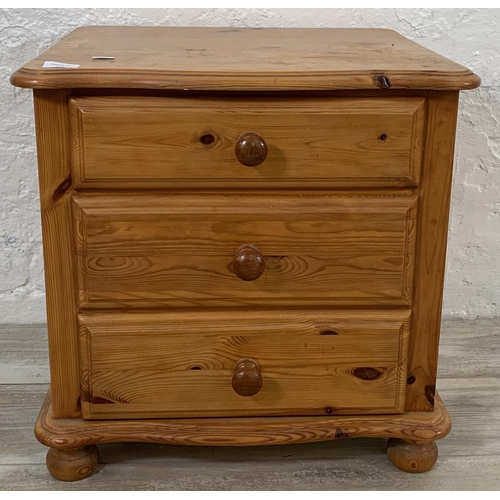 220 - A pine bedside chest of drawers - approx. 52cm high x 52cm wide x 45cm deep