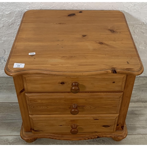 220 - A pine bedside chest of drawers - approx. 52cm high x 52cm wide x 45cm deep