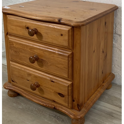 220 - A pine bedside chest of drawers - approx. 52cm high x 52cm wide x 45cm deep