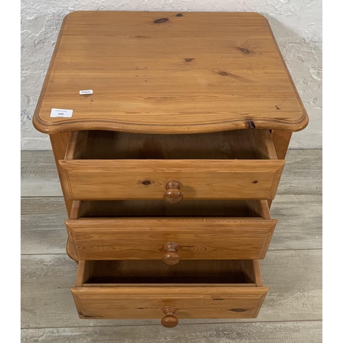 220 - A pine bedside chest of drawers - approx. 52cm high x 52cm wide x 45cm deep