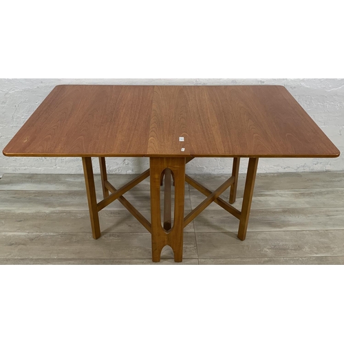 229 - A mid 20th century teak drop leaf gate leg dining table - approx. 74cm high x 83cm wide x 144cm long