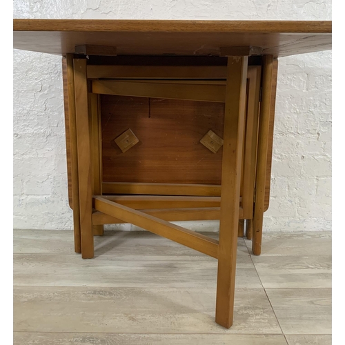 229 - A mid 20th century teak drop leaf gate leg dining table - approx. 74cm high x 83cm wide x 144cm long