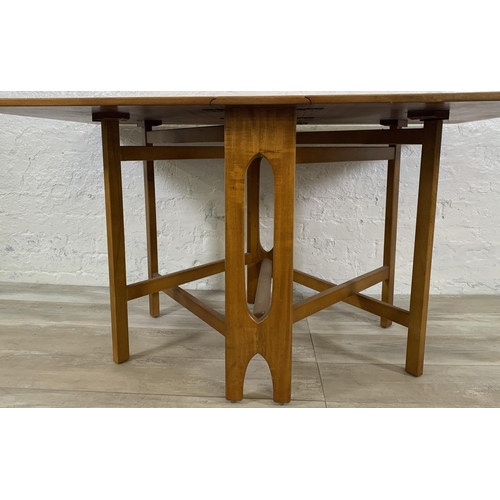 229 - A mid 20th century teak drop leaf gate leg dining table - approx. 74cm high x 83cm wide x 144cm long