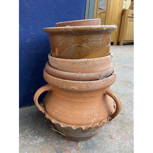 231 - A collection of garden planters to include terracotta, cast stone, blue glazed etc.