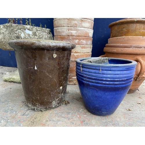 231 - A collection of garden planters to include terracotta, cast stone, blue glazed etc.