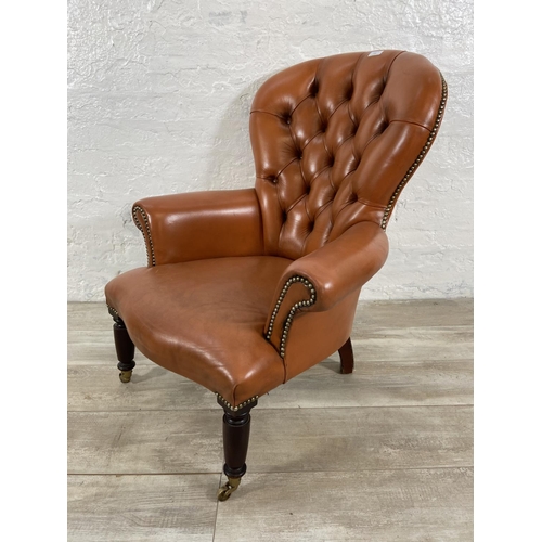 241 - A Victorian style tan leather Chesterfield armchair on turned mahogany supports and brass castors - ... 