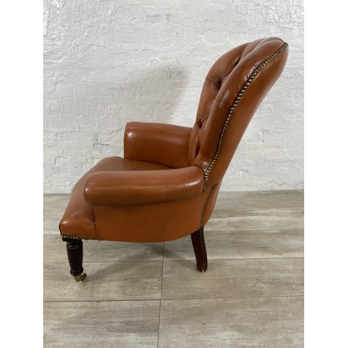 241 - A Victorian style tan leather Chesterfield armchair on turned mahogany supports and brass castors - ... 