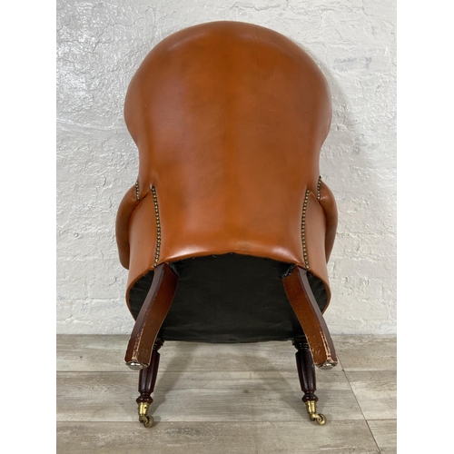 241 - A Victorian style tan leather Chesterfield armchair on turned mahogany supports and brass castors - ... 