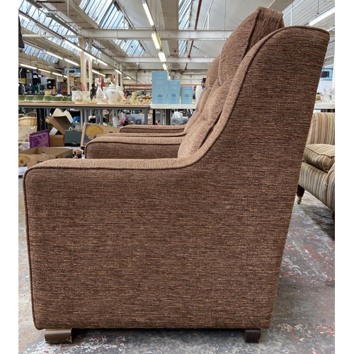 242 - A pair of modern brown fabric upholstered armchairs