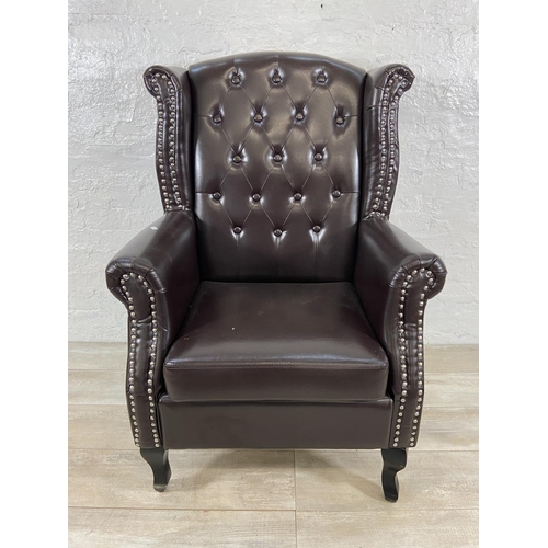 243 - A brown faux leather Chesterfield wingback armchair