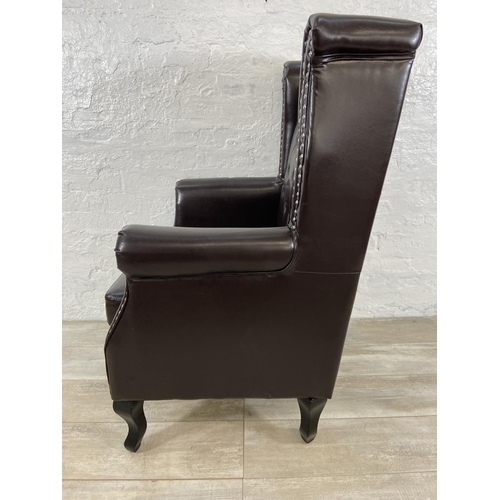 243 - A brown faux leather Chesterfield wingback armchair