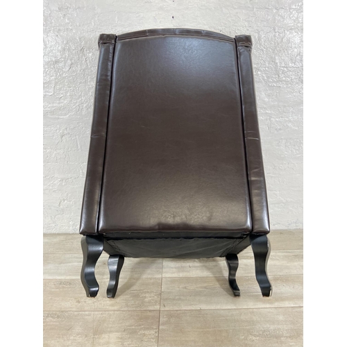 243 - A brown faux leather Chesterfield wingback armchair