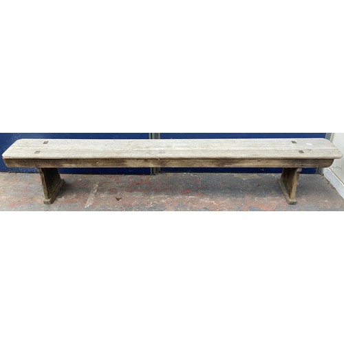 125 - A mid 20th century wooden bench - approx. 44cm high x 245cm wide x 28cm deep