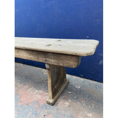 125 - A mid 20th century wooden bench - approx. 44cm high x 245cm wide x 28cm deep