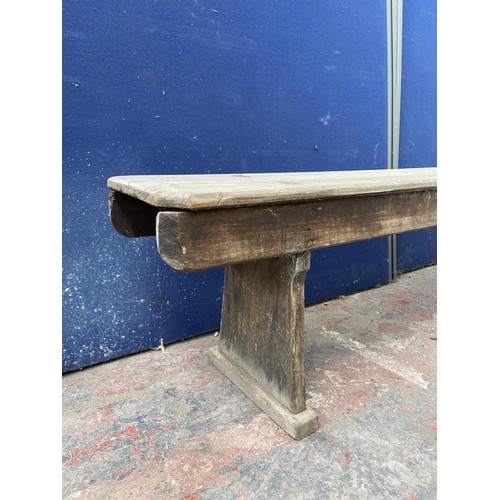 125 - A mid 20th century wooden bench - approx. 44cm high x 245cm wide x 28cm deep