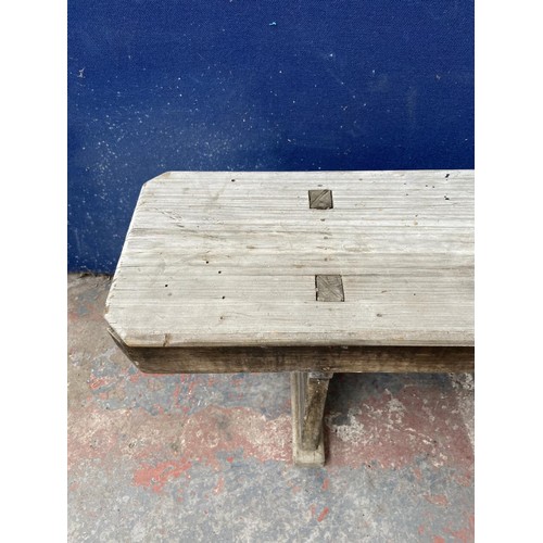 125 - A mid 20th century wooden bench - approx. 44cm high x 245cm wide x 28cm deep