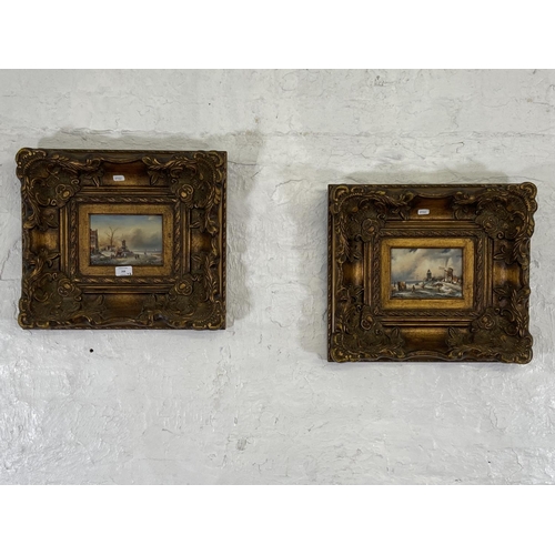 268 - Two gilt framed Adrian Norley oil paintings on board of Dutch frozen river scenes - approx. 41cm hig... 