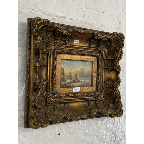 268 - Two gilt framed Adrian Norley oil paintings on board of Dutch frozen river scenes - approx. 41cm hig... 