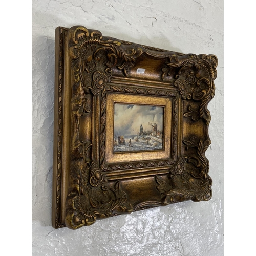 268 - Two gilt framed Adrian Norley oil paintings on board of Dutch frozen river scenes - approx. 41cm hig... 