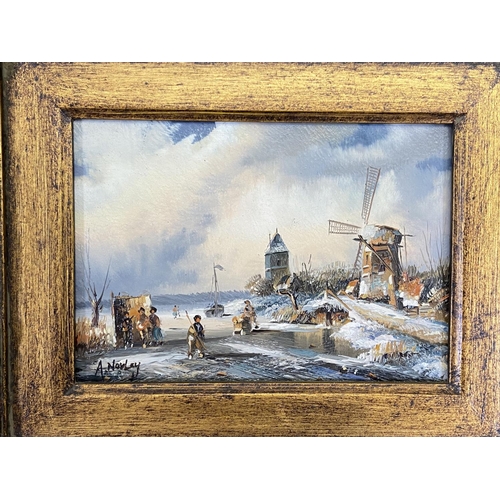 268 - Two gilt framed Adrian Norley oil paintings on board of Dutch frozen river scenes - approx. 41cm hig... 