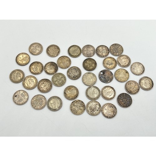 2211 - A collection of British silver threepence coins, sixteen .500 silver - approx. gross weight 22g and ... 