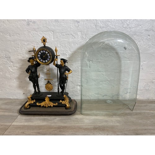 183 - A French Japy Freres gilded spelter figural two train clock with glass dome, pendulum and key on ebo... 