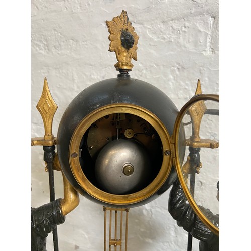 183 - A French Japy Freres gilded spelter figural two train clock with glass dome, pendulum and key on ebo... 