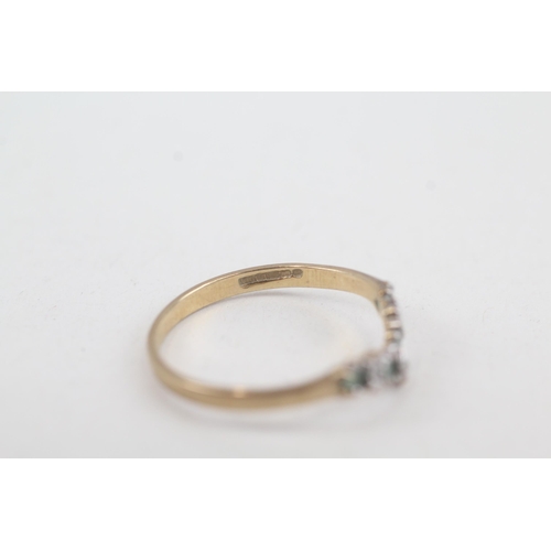 2073 - A 9ct gold emerald and diamond wishbone ring - approx. gross weight 1.1g