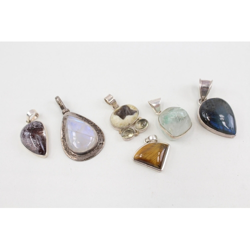 2094 - Six .925 silver gemstone set pendants to include moonstone, tiger's eye etc. - approx. gross weight ... 