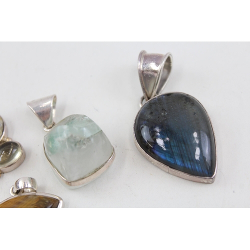 2094 - Six .925 silver gemstone set pendants to include moonstone, tiger's eye etc. - approx. gross weight ... 