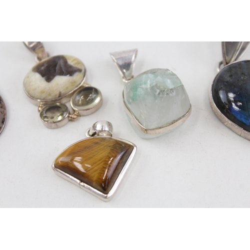 2094 - Six .925 silver gemstone set pendants to include moonstone, tiger's eye etc. - approx. gross weight ... 