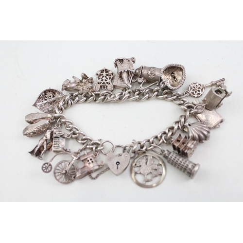 2098 - A sterling silver charm bracelet with assorted charms - approx. gross weight 79g