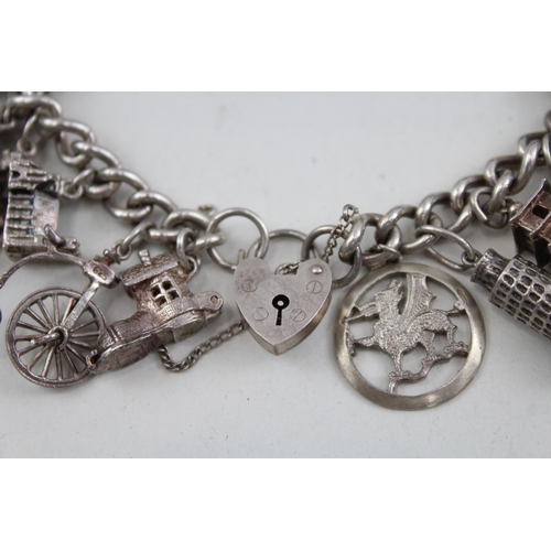 2098 - A sterling silver charm bracelet with assorted charms - approx. gross weight 79g