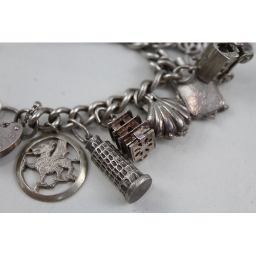 2098 - A sterling silver charm bracelet with assorted charms - approx. gross weight 79g