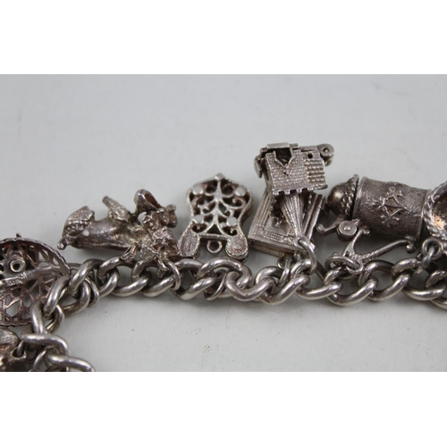 2098 - A sterling silver charm bracelet with assorted charms - approx. gross weight 79g