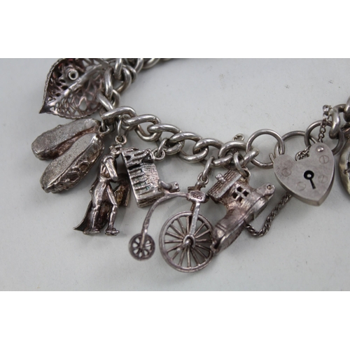 2098 - A sterling silver charm bracelet with assorted charms - approx. gross weight 79g