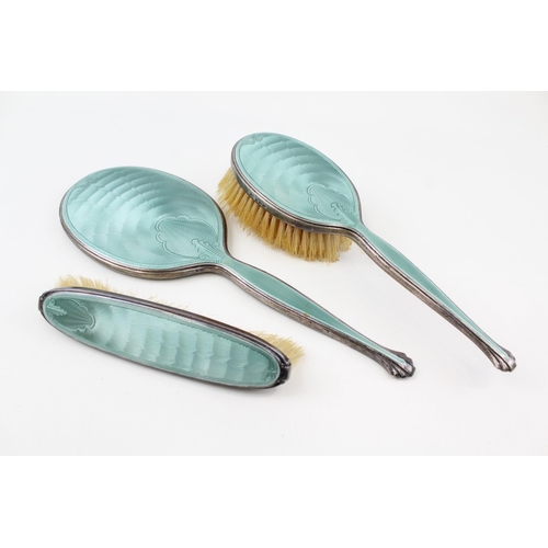 2202 - An Art Deco hallmarked Birmingham silver and guilloche enamel three piece dressing table set, dated ... 