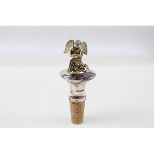 2204 - A hallmarked sterling silver angel topped bottle stopper