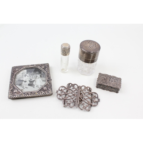 2208 - Five .925 sterling silver items to include belt buckle, photo frame, vanity jars etc.