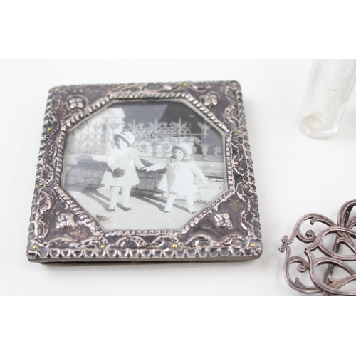 2208 - Five .925 sterling silver items to include belt buckle, photo frame, vanity jars etc.