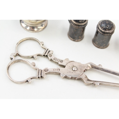 2209 - Five pieces of hallmarked sterling silver to include scissor shaped sugar tongs, salt and pepper sha... 