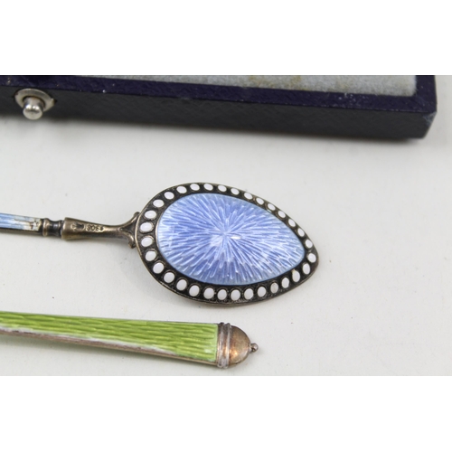 2213 - Three hallmarked sterling silver and guilloche enamel items, two teaspoons and one cased knife