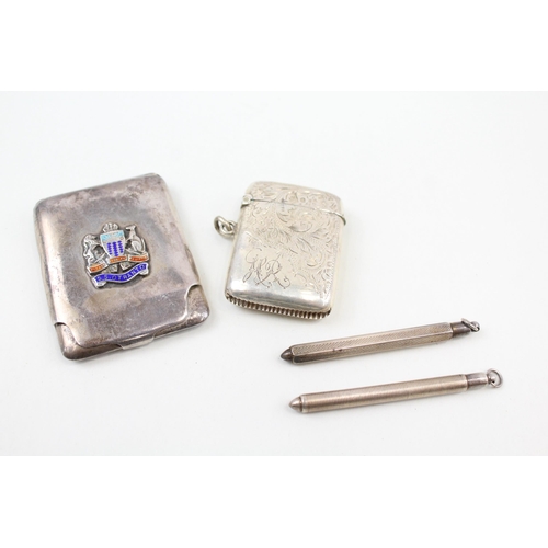 2216 - Four pieces of hallmarked sterling silver, one vesta case, two toothpicks and one souvenir matchbook... 