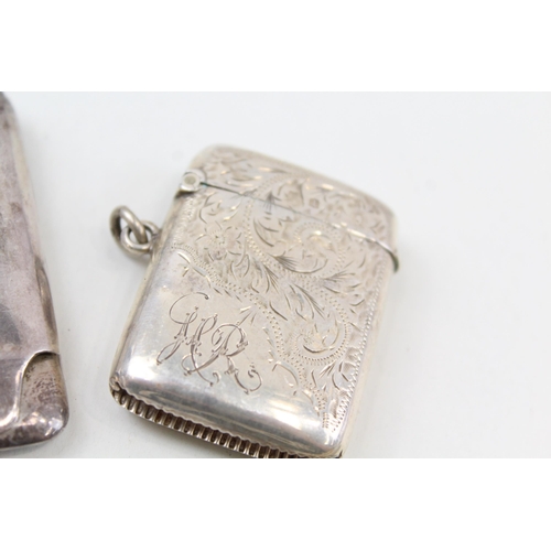 2216 - Four pieces of hallmarked sterling silver, one vesta case, two toothpicks and one souvenir matchbook... 