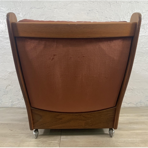 1 - A mid 20th century G Plan teak and fabric upholstered saddleback armchair on castors - approx. 83cm ... 