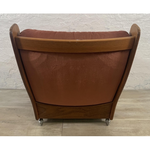 1 - A mid 20th century G Plan teak and fabric upholstered saddleback armchair on castors - approx. 83cm ... 