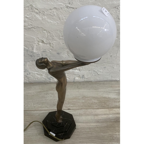 10 - An Art Deco style bronzed nude lady figural table lamp with opaque spherical shade and marble effect... 