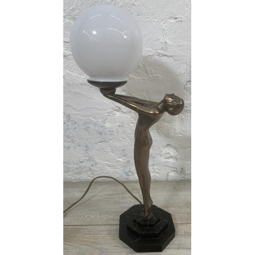 10 - An Art Deco style bronzed nude lady figural table lamp with opaque spherical shade and marble effect... 